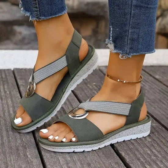 Overhead shot of the Artemis sandals in black, showing the adaptive fit of the elastic straps.