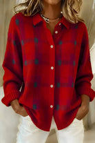 Side profile of the orange Inez button-up cardigan, highlighting the loose fit and button detailing.