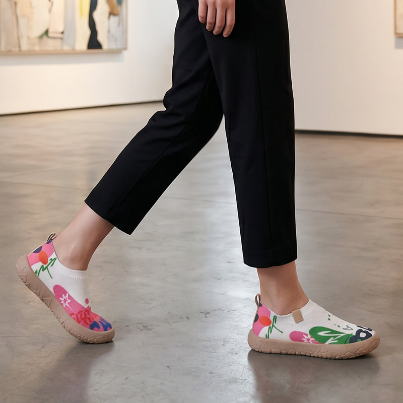 Close-up detail of the fuchsia artistic pattern on the breathable mesh upper of the slip-on shoes.
