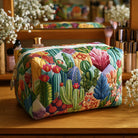 Overhead view of a Kiera quilted cosmetic bag in succulent plants print, featuring a secure zip closure.