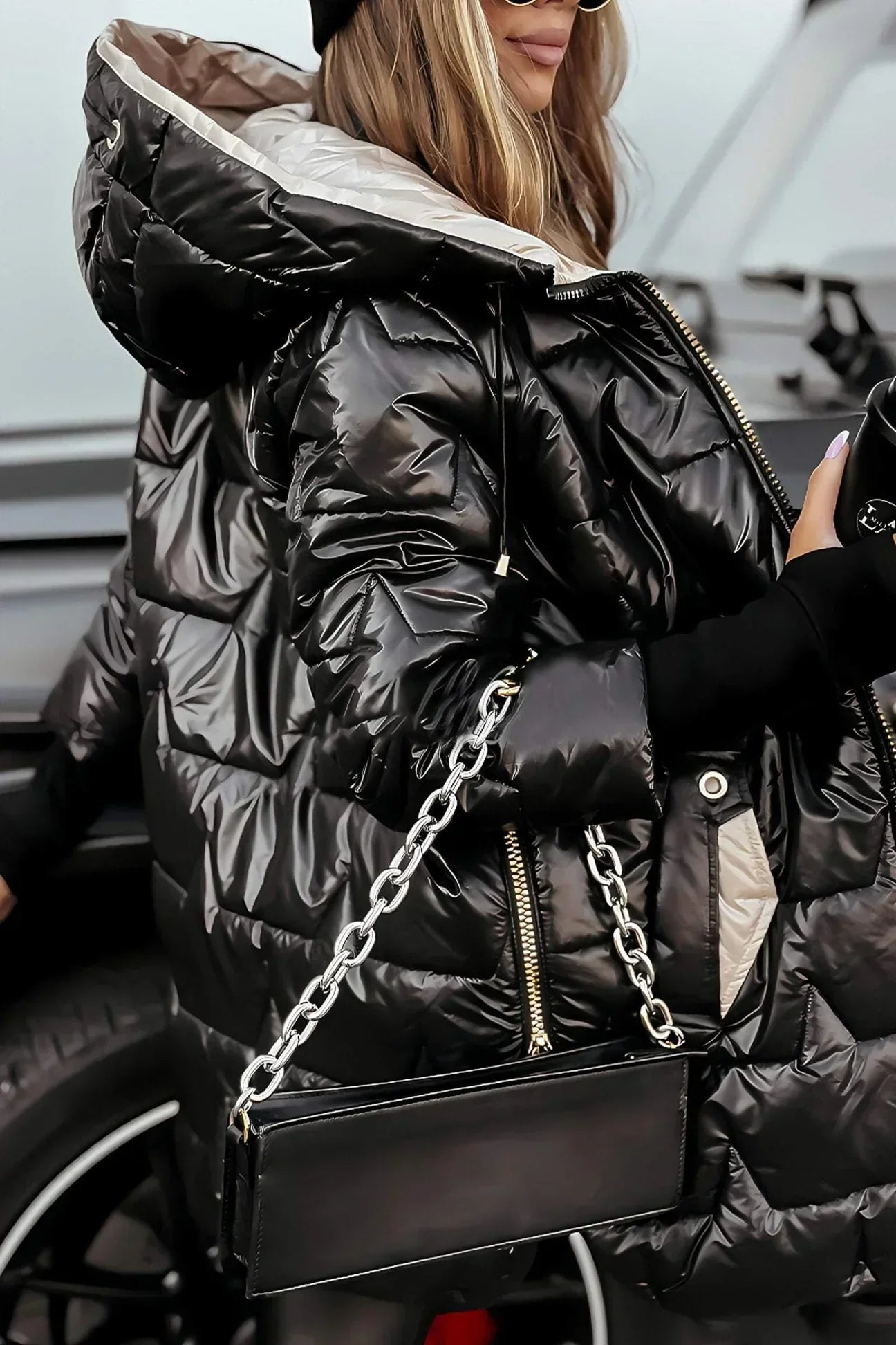 Frontal view of a brown Kiera hooded winter jacket with the hood up.