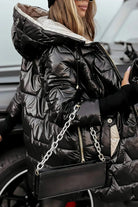Frontal view of a brown Kiera hooded winter jacket with the hood up.