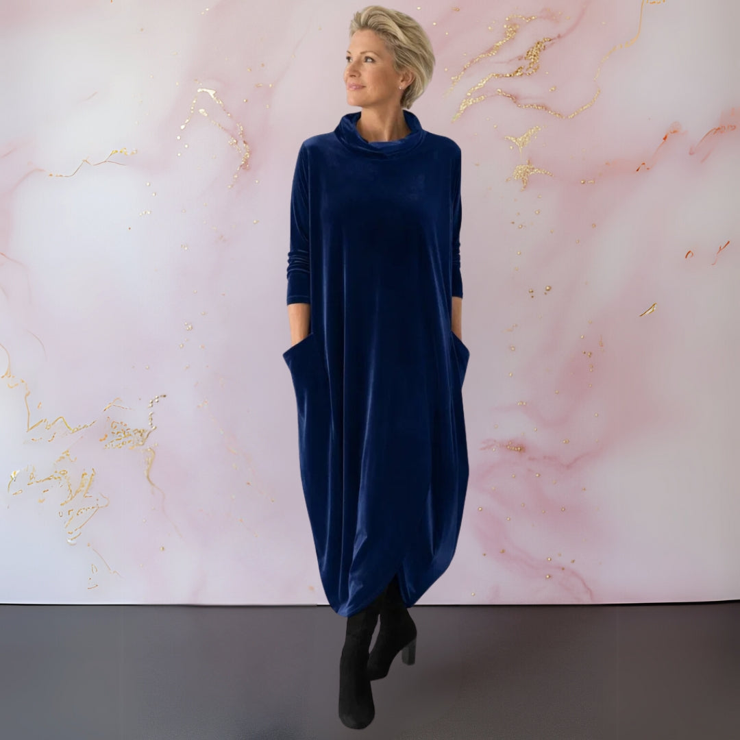 Side profile of a woman in the Leona velvet maxi dress, illustrating the flowing fit and integrated side pockets.