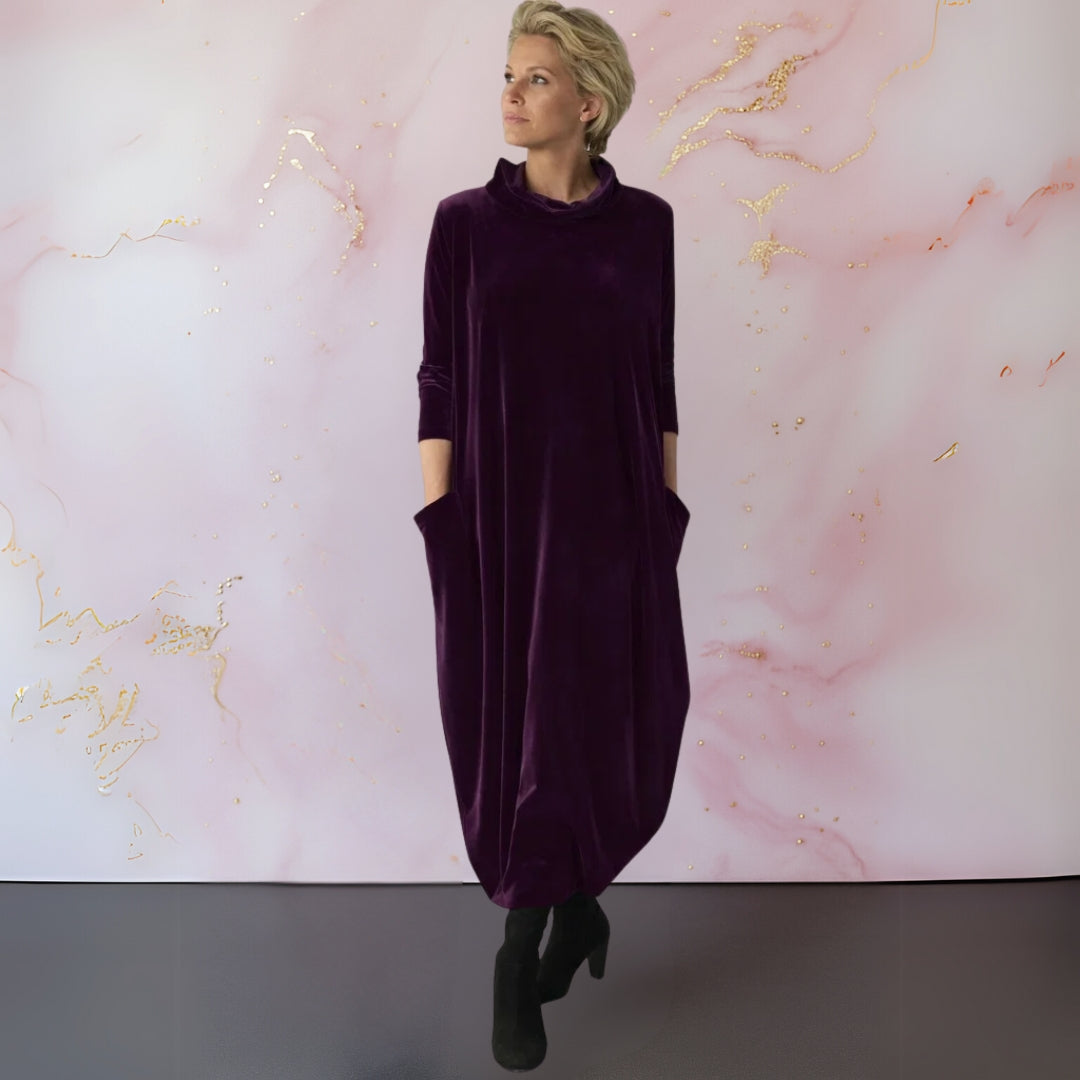 Rear view of the Leona velvet maxi dress, highlighting the graceful fall of the fabric and overall versatile design.