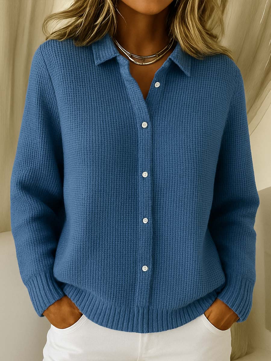 Detail of the fine knit texture and button closure on the Lila cardigan.