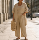 Close-up detail of the linen-look fabric texture on the Lila relaxed three-piece set, highlighting its breathable quality.