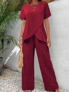 Side profile of a woman in green wide-leg pants, showcasing the flow and drape of the fabric.