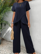 Woman walking in navy wide-leg pants, demonstrating freedom of movement and elegant stride.