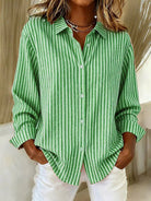 Side profile of a model wearing the green Linnea relaxed fit shirt, highlighting its loose drape and long sleeves.