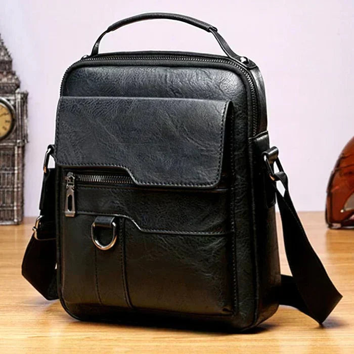 Caleb shoulder bag worn over the shoulder by a man in a professional setting, emphasizing its versatile appeal.