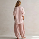 Full-length shot of elegant black high-waisted trousers, showcasing their flattering wide-leg silhouette.