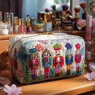 Front view of the Margot handmade cosmetic bag featuring a festive nutcracker print on quilted fabric.