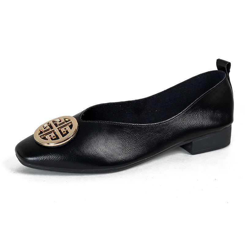 A pair of classic black square-toe flats displayed next to casual denim jeans, illustrating versatile styling.