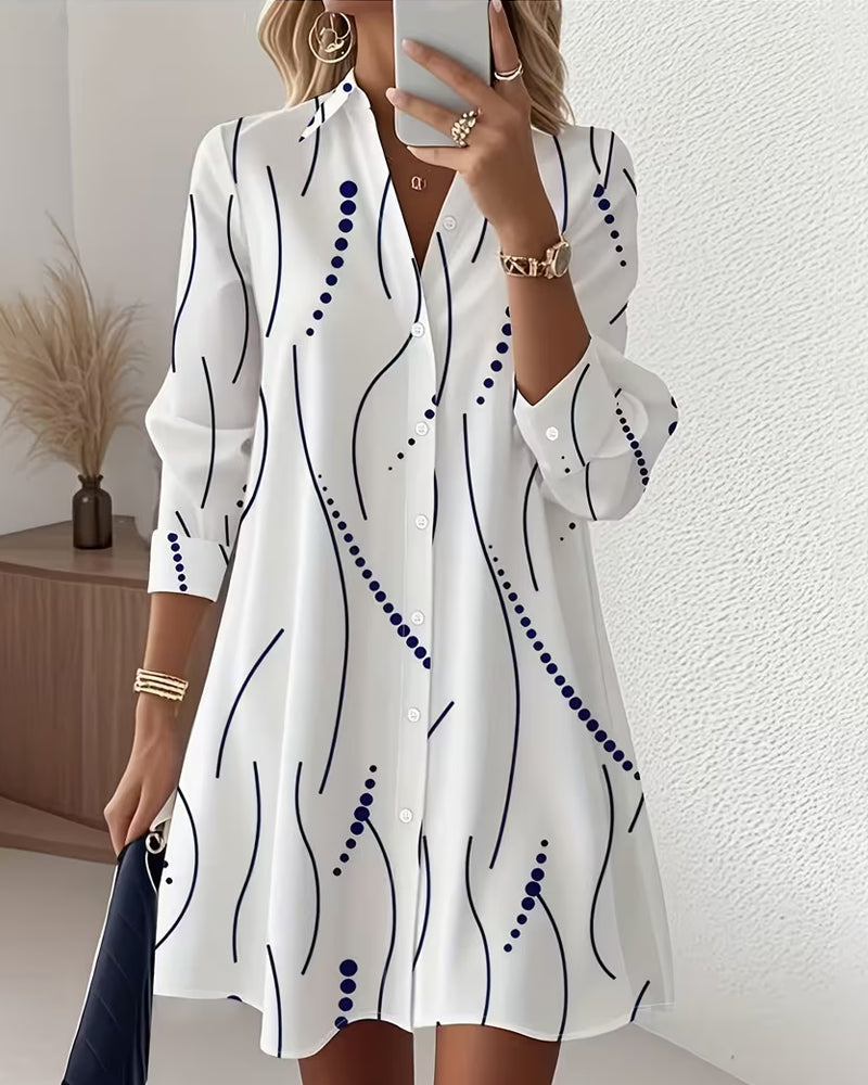 Front view of the Kira striped A-line dress in white, showcasing its wavy pattern and lapel collar.