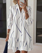 Side profile of a model wearing the white Kira striped A-line dress, highlighting the regular fit and above-knee length.