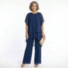 Front view of a model wearing a navy Tamsin tiered blouse, showcasing its elegant drape and short floaty sleeves.