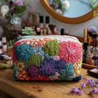 Front view of the Odette quilted cosmetic bag in a vibrant cactus print on a light background, showcasing its texture and design.