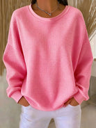 Overhead view of the Odette knit sweater in pink, highlighting its overall soft texture and design.