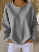 Close-up detail of the visible knit structure on the Odette sweater in gray, showing quality.