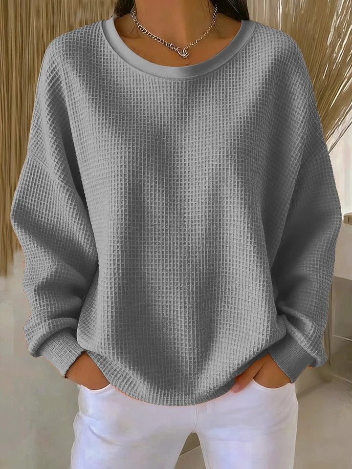 Close-up detail of the visible knit structure on the Odette sweater in gray, showing quality.