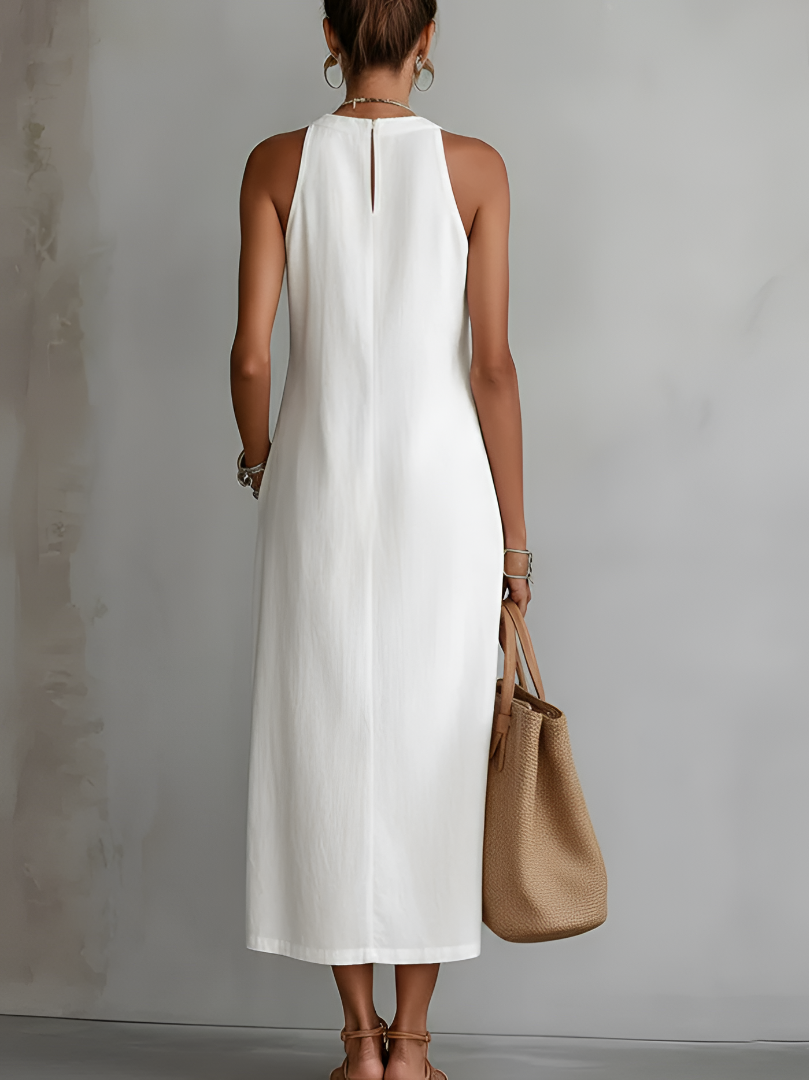 Side profile of a model wearing the green midi dress, highlighting the flattering silhouette and practical side pockets.