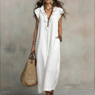 Back view of the Saskia long maxi dress, highlighting the elegant drape of the natural fabric.