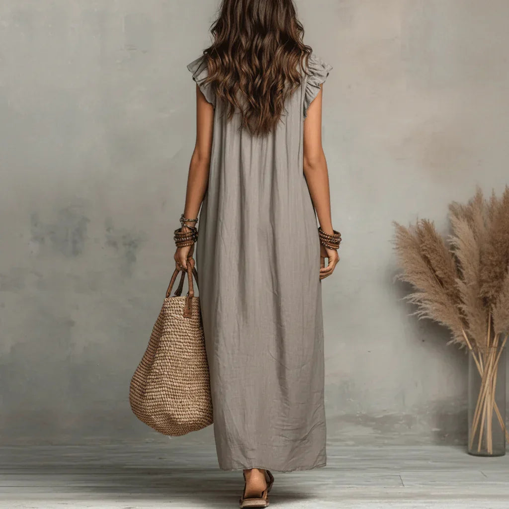 A woman twirling gently, emphasizing the free-flowing nature of the bohemian long maxi dress.