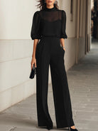Front view of the Romy black chiffon three-piece set on a model, showcasing the sheer top and wide-leg trousers.