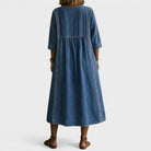 Side profile of a woman in the Romy denim jeans, highlighting the flowing cut and overall silhouette.