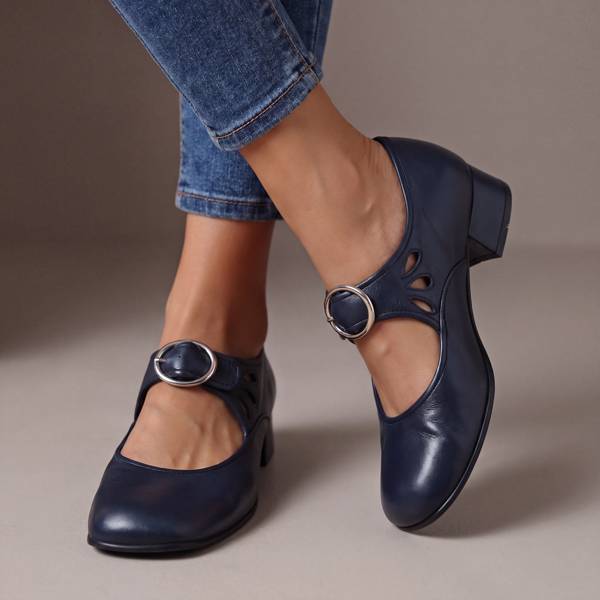 Side profile of a navy blue Mary Jane shoe, emphasizing the stable low heel and smooth finish for confident steps.