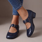 Side profile of a navy blue Mary Jane shoe, emphasizing the stable low heel and smooth finish for confident steps.