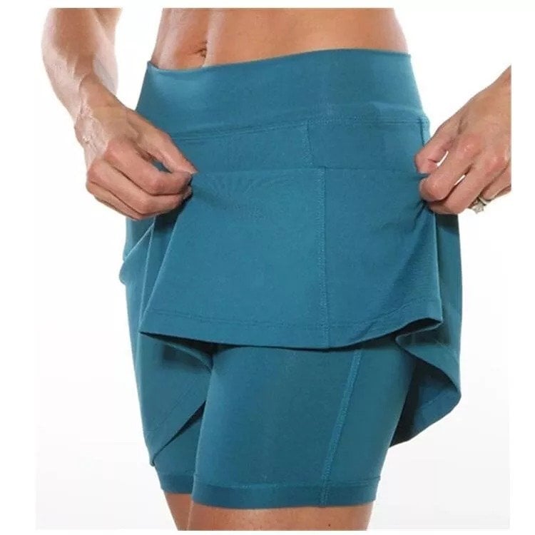 Sunny day scene with a model in the orange skort, emphasizing its suitability for warm weather.