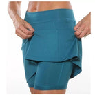 Sunny day scene with a model in the orange skort, emphasizing its suitability for warm weather.