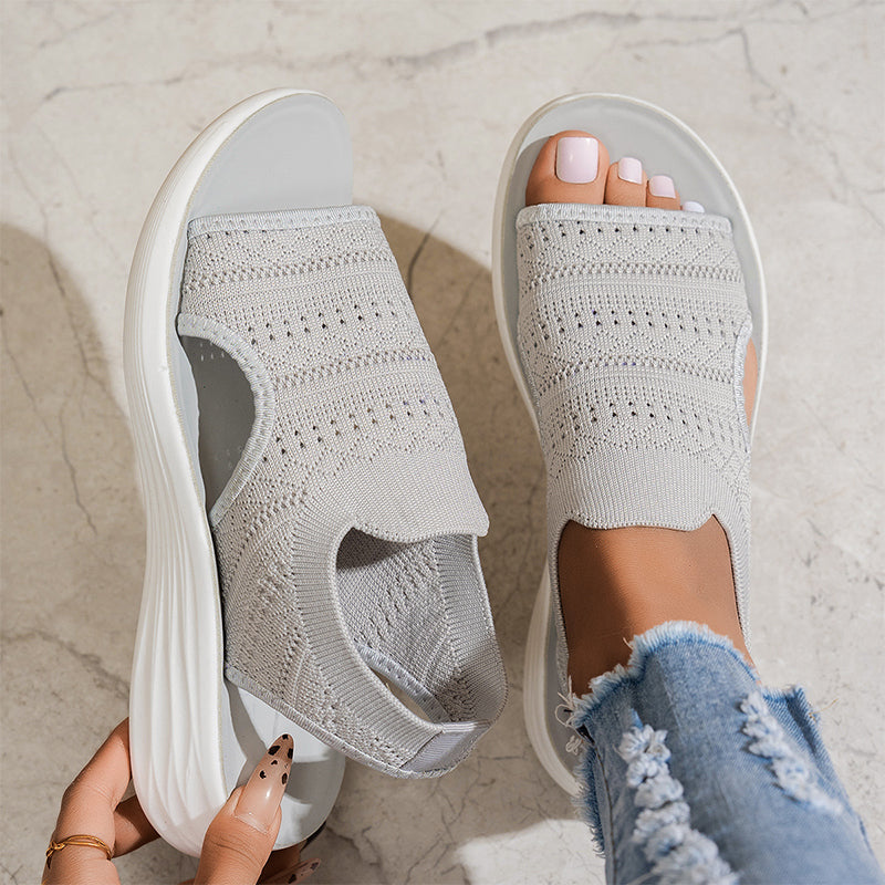 Close-up of the breathable knit material on a pink pair of platform sandals, emphasizing texture and ventilation.