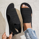 Side profile of beige knit platform sandals, highlighting the supportive platform and flexible design.